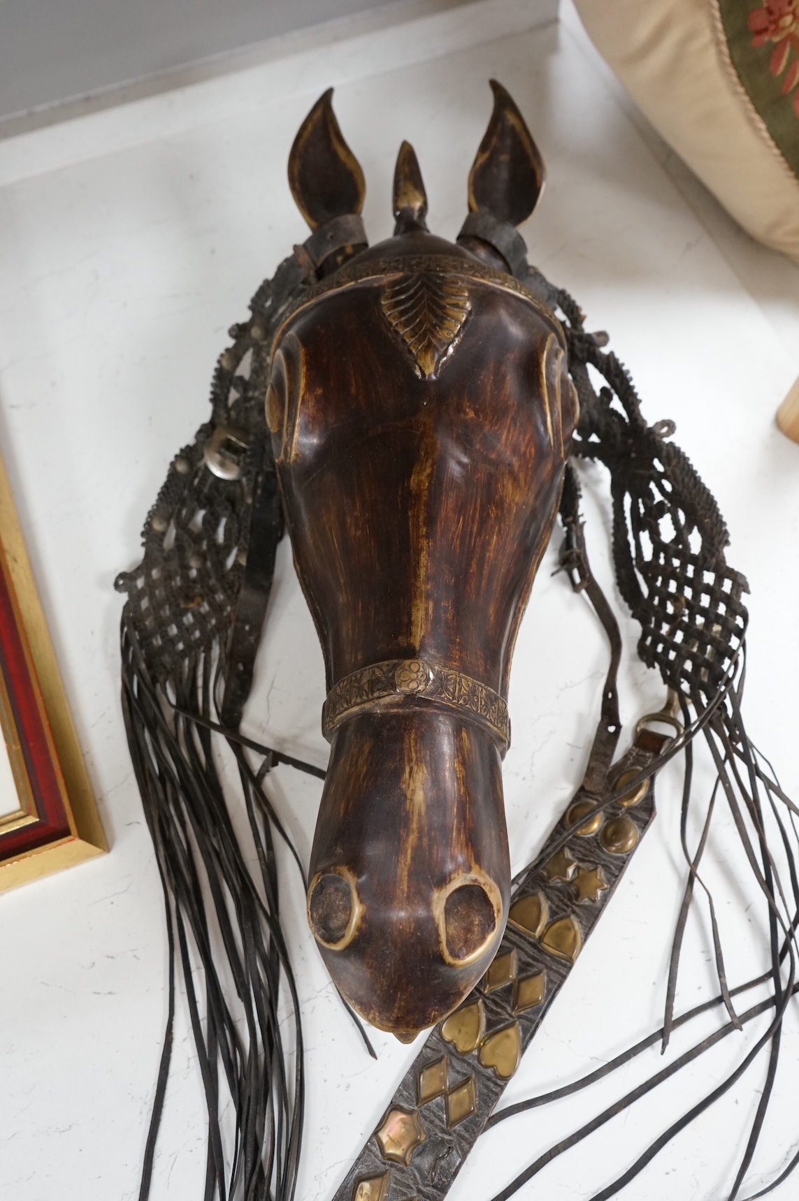 A bronze model horse’s head with martingale hanging, 55cm high